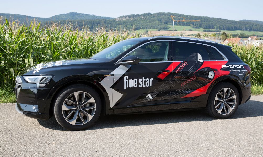 Beschrifteter schwarzer Audi Etron mit Skisujet und Aufschrift five star.